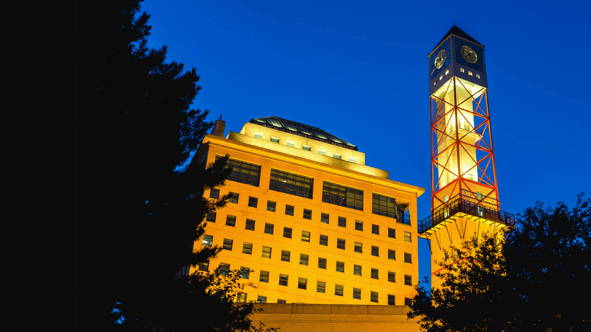 The Civic Centre clock tower lit up yellow and green.